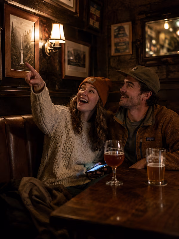 A couple playing a live puzzle experience together on their phones